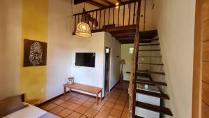 eine Treppe in einem Zimmer mit einer Bank und einem TV in der Unterkunft Casa Saimiri in Alter do Chao