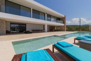 a villa with a swimming pool and a house at Lemon Tree Villa in Gialova