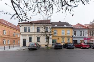 a group of buildings with cars parked in a parking lot at Apartma Lea in Slovenj Gradec