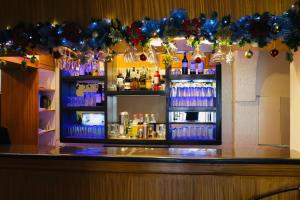 a bar with a lot of drinks and christmas decorations at AMALFI718 HOTEL in Lipa