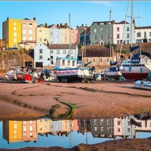 a group of boats parked in a marina with buildings at Sea Crest, Beautiful home in Tenby with sea views in Pembrokeshire