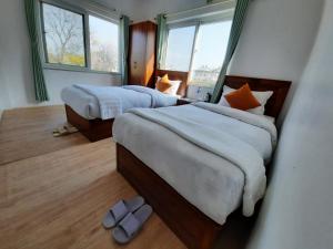 Postel nebo postele na pokoji v ubytování Eco Inn Guest House