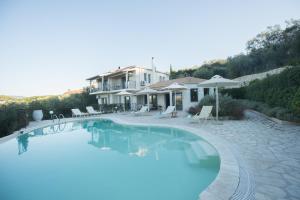 a large swimming pool in front of a house at Villa Sania in Kassiopi