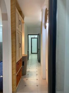 a hallway leading to a room with a door and a tile floor at the second home of yours in Hanoi