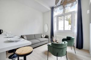ein Wohnzimmer mit einem Sofa und einem Tisch in der Unterkunft Luxurious Apartement - Near the Eiffel Tower Champs de Mars in Paris