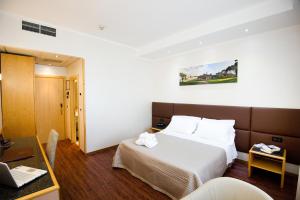 Postel nebo postele na pokoji v ubytování Hotel Minerva