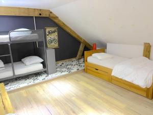 a bedroom with two bunk beds and a staircase at gérardmer plein centre idéal famille in Gérardmer
