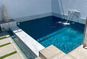 RooielsにあるProteus Beach Houseの庭の噴水付きスイミングプール