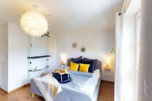 a bedroom with a bed with yellow pillows at Wohlfühl-Wohnen in Düren in Düren - Eifel