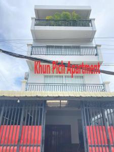 a kum rich apartment building with a sign on it at Khun Pich Apartments in Siem Reap