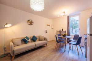 a living room with a couch and a table at Appartement Sauge in Martigues