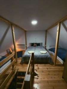 a bedroom with a large bed in a attic at Casa Vidica in Kopaonik