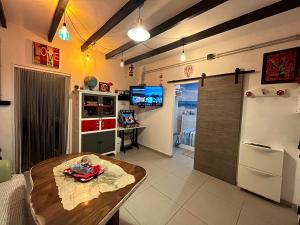 a kitchen with a table and a refrigerator at Anuli & Beach & Family - Fuengirola & Malaga in Fuengirola