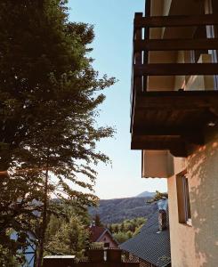 a view from a balcony of a building with a tree at Casa Vidica in Kopaonik