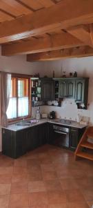 a kitchen with green cabinets and a sink at Deák Vendégház Dörgicse in Dörgicse