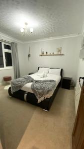 a bedroom with a bed with a zebra blanket at Large 4 Bedrooms House in Coventry for Contractors in Whitley