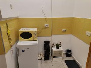 a small kitchen with a microwave on top of a refrigerator at Apartment Marko in Zagreb