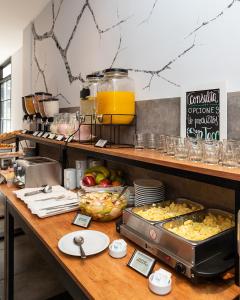 a kitchen with a counter with food on it at HOTEL CONCEPT BARILOCHE in San Carlos de Bariloche