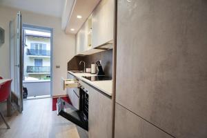 a kitchen with a sink and a counter at Modern Apartment on the Mt.Baldo & Garda Lake in Brentonico