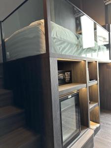 an open bunk bed with a mirror in a room at HOTEL JJH - newly opened near BUGIS in Singapore
