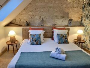 a bedroom with a large white bed with two lamps at Aquarelle in Sainte-Maure-de-Touraine