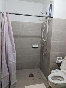 a bathroom with a shower and a toilet at Mesatierra Garden Residences in Davao City