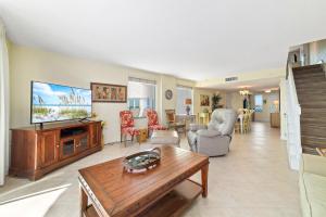 a living room with a television and a table at Perdido Towers East 106 in Perdido Key