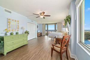 a living room with a ceiling fan and a bedroom at Perdido Towers East 106 in Perdido Key