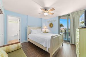 a bedroom with a bed and a ceiling fan at Perdido Towers East 106 in Perdido Key +32 photos
