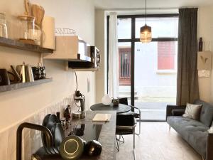 a living room with a couch and a table at Serene Sixteen - Valence Centre Ville in Valence