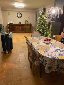 a dining room with a table with a christmas tree at 3L Villa near Paris. Jacuzzi/Sauna/Massage in Argenteuil