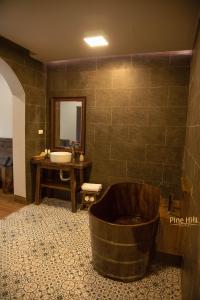 a large bathroom with a tub and a sink at Sapa Pine Hill Eco Lodge in Sa Pa