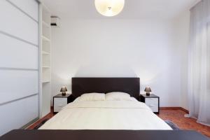 a bedroom with a large bed and two night stands at Holiday Home "Opatija" in Opatija