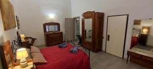a bedroom with a red bed and a mirror at Classy central apartment in Bari