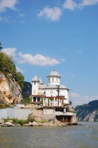 a building sitting on the side of a river at Casa Adelin in Eşelniţa