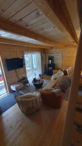 Planinska brvnara في كوبريس: غرفة معيشة مع أرائك في كابينة خشب