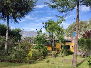 uma casa com jardim e árvores em Kinti Wasi Casa de Campo em Los Baños del Inca