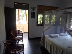 Postel nebo postele na pokoji v ubytování Sunil Garden Guesthouse