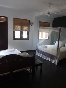 Postel nebo postele na pokoji v ubytování Sunil Garden Guesthouse