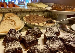 a plate of brownies and bread on a table at Pousada Gramado in Gramado