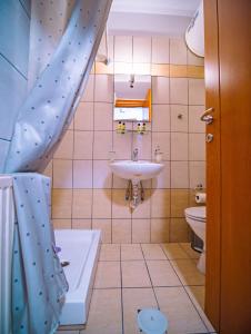 a bathroom with a sink and a shower curtain at Small Nest - Central Spot Apartments in Volos