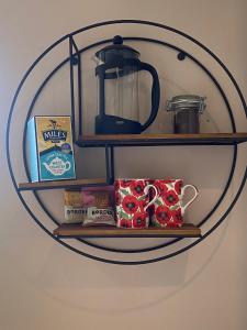 a round shelf with a tea kettle on it at The Loft at Pen Orchard in Winscombe