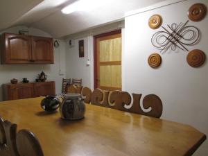 a dining room with a wooden table and chairs at Chalupa Maršovice in Nové Město na Moravě