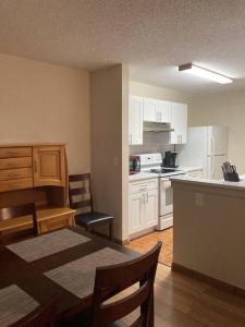 a kitchen with white cabinets and a table and chairs at Lakeview Condo in Gated Community in Tampa