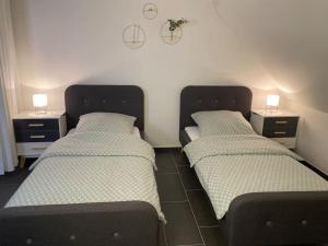 two beds sitting next to each other in a room at Gemütliche Wohnung in Ahaus