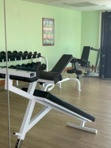 a gym with two treadmills and exercise bikes at Supalai Oriental Place in Bangkok