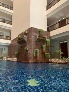 a swimming pool in the middle of a building at Supalai Oriental Place in Bangkok