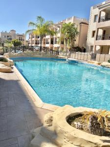 a large swimming pool in front of some buildings at Royal Seacrest new apartment B G2 ground floor in Paphos