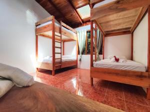 a bedroom with two bunk beds in a room at ICO Living Hostel in Santa Teresa Beach