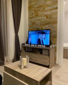 a living room with a flat screen tv on a wooden entertainment center at Milmari S50 in Kopaonik